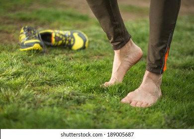  Male runner relaxing after outdoor jogging, workout in spring park. focus on right foot - Powered by Shutterstock