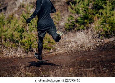 Male Runner Run Down Mountain In Muddy Trail