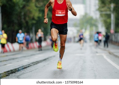 Male Runner Running City Marathon Race At Number 1