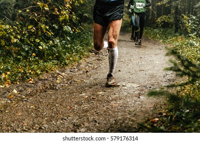 Male Runner Runs Marathon Forest Trail Feet In Mud