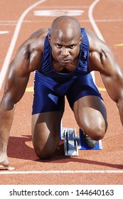 Male Runner Waiting At The Starting Block On Race Track