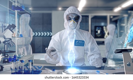 Male Scientist analyzing and interacting with a 3D Rotating DNA Molecule Hologram in a Secure High Level Modern Laboratory. Genetic Engineering Research Facility. - Powered by Shutterstock