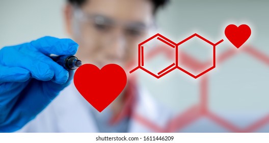 A Male Scientist Is Writing A Formula For The Heart Chemistry In Love On Valentine's Day.