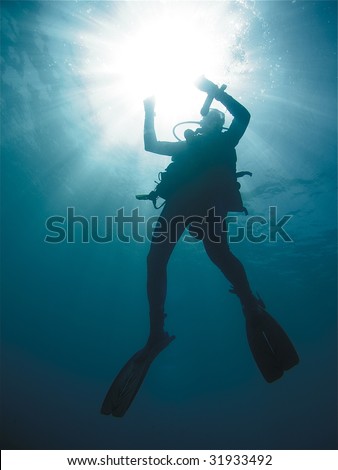 Similar – Man in his back with scuba diving equipment exploring the ocean floor.