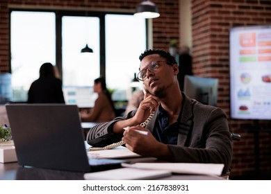 Male Secretary Wheelchair User Answering Landline Phone Call, Having Remote Conversation On Telephone Line In Disability Friendly Office. Man With Chronic Impairment Using Telework Chat Line.