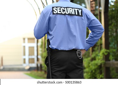 Male Security Guard Protecting House Outdoor