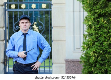 Male Security Guard Protecting House Outdoor