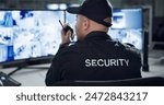 Male security guard, radio and speaking by cctv monitor for protection, data center or building safety. Inspection, video surveillance agency and control room with footage, back view and computer