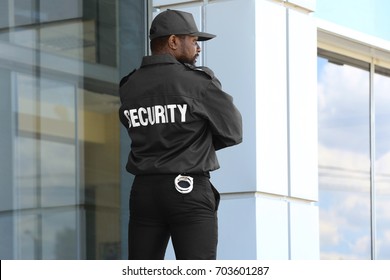 male-security-guard-standing-near-260nw-703601287.jpg