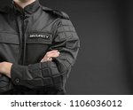 Male security guard in uniform on dark background, closeup