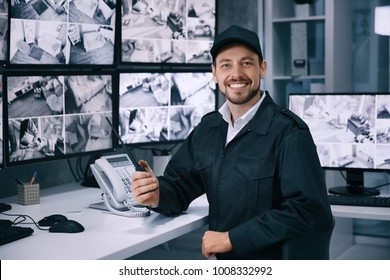 Male Security Guard Working In Surveillance Room