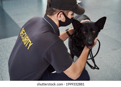 Male Security Officer With Detection Dog Working At Airport