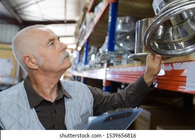 Male Senior Worker In Storeroom