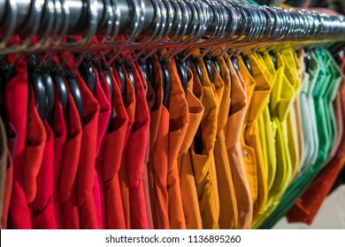 Male Men’s Shirts Sorted In Color Order On Hangers On A Thrift Shop Or Wardrobe Closet Rail