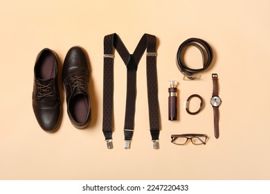 Male shoes and accessories on beige background