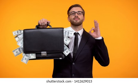 Male Showing Briefcase With Money And Doing Ok Gesture, Payday Lending Service