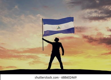 Male silhouette figure waving Nicaragua flag. 3D Rendering