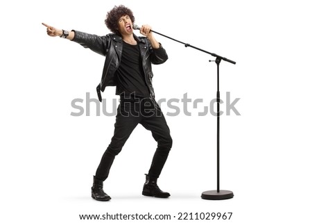 Male singer in a leather jacket singing loud on a microphone isolated on white background