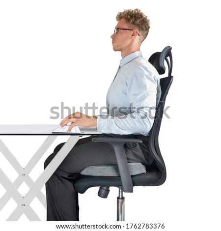 Male sitting on office chair at desk with good posture and support