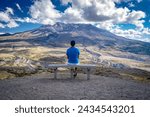 Male sitting on a park bench in Mount St. Helens National Volcanic Monument, WA, USA