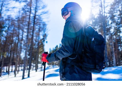 male skier wearing ski googles mask and professional equipment skis ourdoors in russian forest