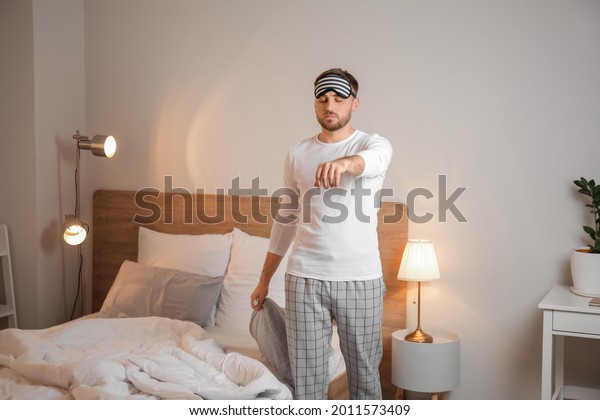 Male sleepwalker in\
bedroom at night