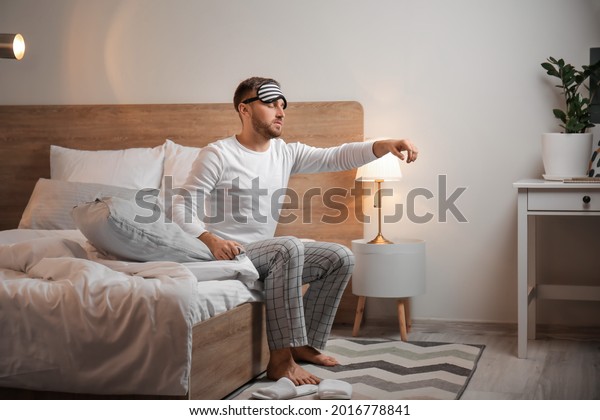 Male sleepwalker in\
bedroom at night