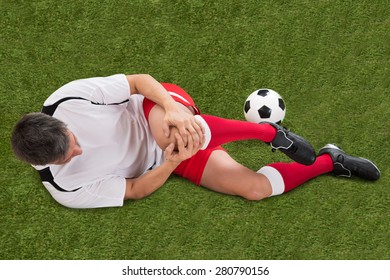 Male Soccer Player Suffering From Injury In Knee