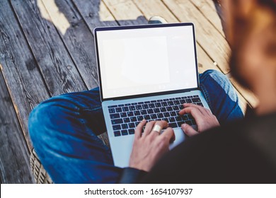 Male Software Developer Updating Application And Typing Program Text During Remote Work Outdoors,millennial Man Searching Data Information On Website Connected To 4g Wireless Internet On Mockup Laptop