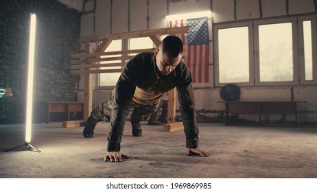 Male soldier doing push ups and taking break - Powered by Shutterstock