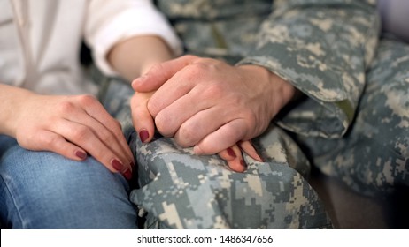 Male soldier holding girlfriends hand, farewell before military service, love - Powered by Shutterstock