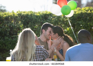 Male Soldier Kissing Wife At Homecoming Party