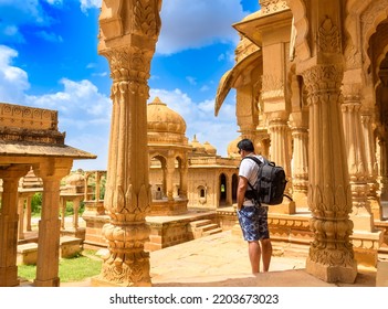 A Male Solo Traveler at the Ruined Cenotaphs of Bada Bagh, also called Grand Garden at Jaisalmer in the Indian state of Rajasthan.    - Shutterstock ID 2203673023