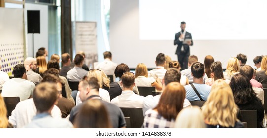 Male speaker giving a talk in conference hall at business event. Audience at the conference hall. Business and Entrepreneurship concept. Focus on unrecognizable people in audience. - Shutterstock ID 1414838378
