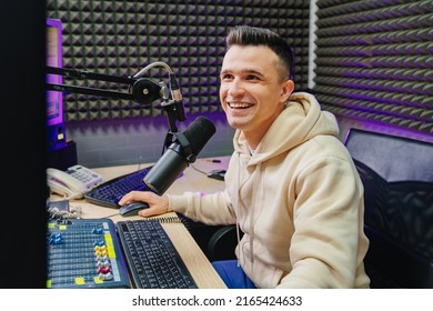 A Male Sports Speaker Is Conduct A Live Broadcast In A Professional Radio Studio. A Classic Creative Profession For Professional Presenters.