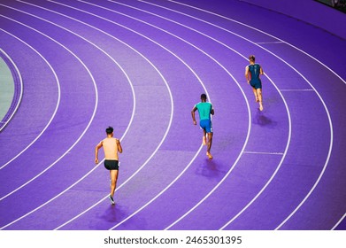 Male sprinters at purple Paris track. Concept photo for summer games in Paris 2024. Athletics and elite athletes in action - Powered by Shutterstock