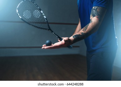 Male squash player training on indoor court - Shutterstock ID 644248288