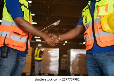 Male Staff Workers Shaking Hands With Deals In Warehouse, Success Collaboration Concept, Teamwork.