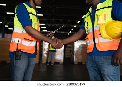 Male Staff Workers Shaking Hands With Deals In Warehouse, Success Collaboration Concept, Teamwork.