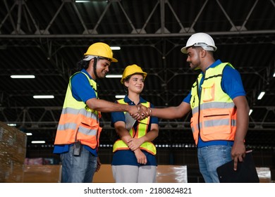 Male Staff Workers Shaking Hands With Deals In Warehouse, Success Collaboration Concept, Teamwork.