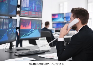Male stock trader working in office - Shutterstock ID 757791643