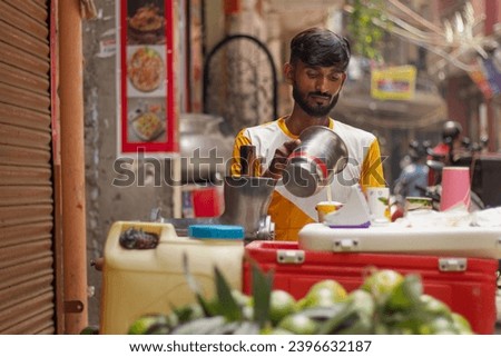 Male street vendor making fruit juice at his juice shop