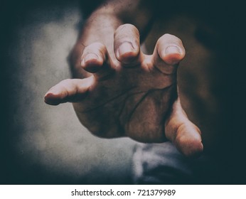 a hand grabbing for someone in the darkness
