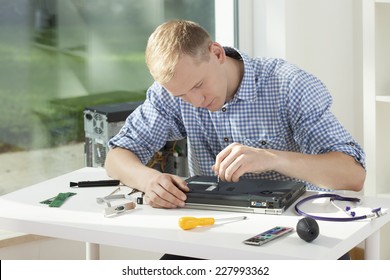 Male Student During Repair Of His Laptop