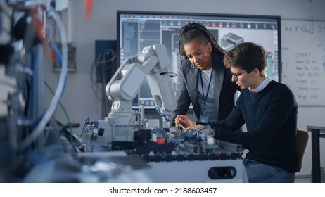 Male Student Engineer Discussing Ideas with Black Teacher while Working with Computer Processor. Man Uses Screwdriver. High-Tech Science and Engineering Concept. Medium Shot
