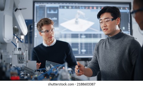 Male Student Gesturing And Holding Tablet While Working On Project With Classmate And Black Teacher. People Analysing Modern Technologies During Lesson. Science And Developing Concept.