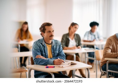 Male Student Paying Attention During A Class At Lecture Hall.