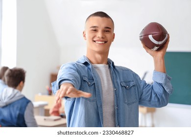 Male student with rugby ball in classroom - Powered by Shutterstock