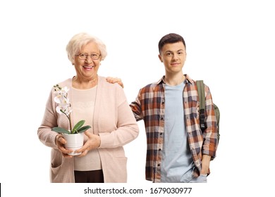 Male Student Standing Next To An Older Lady With A White Orchid Plant In Her Hands Isolated On White Background