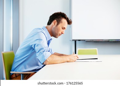 Male Student Taking A Writing Exam